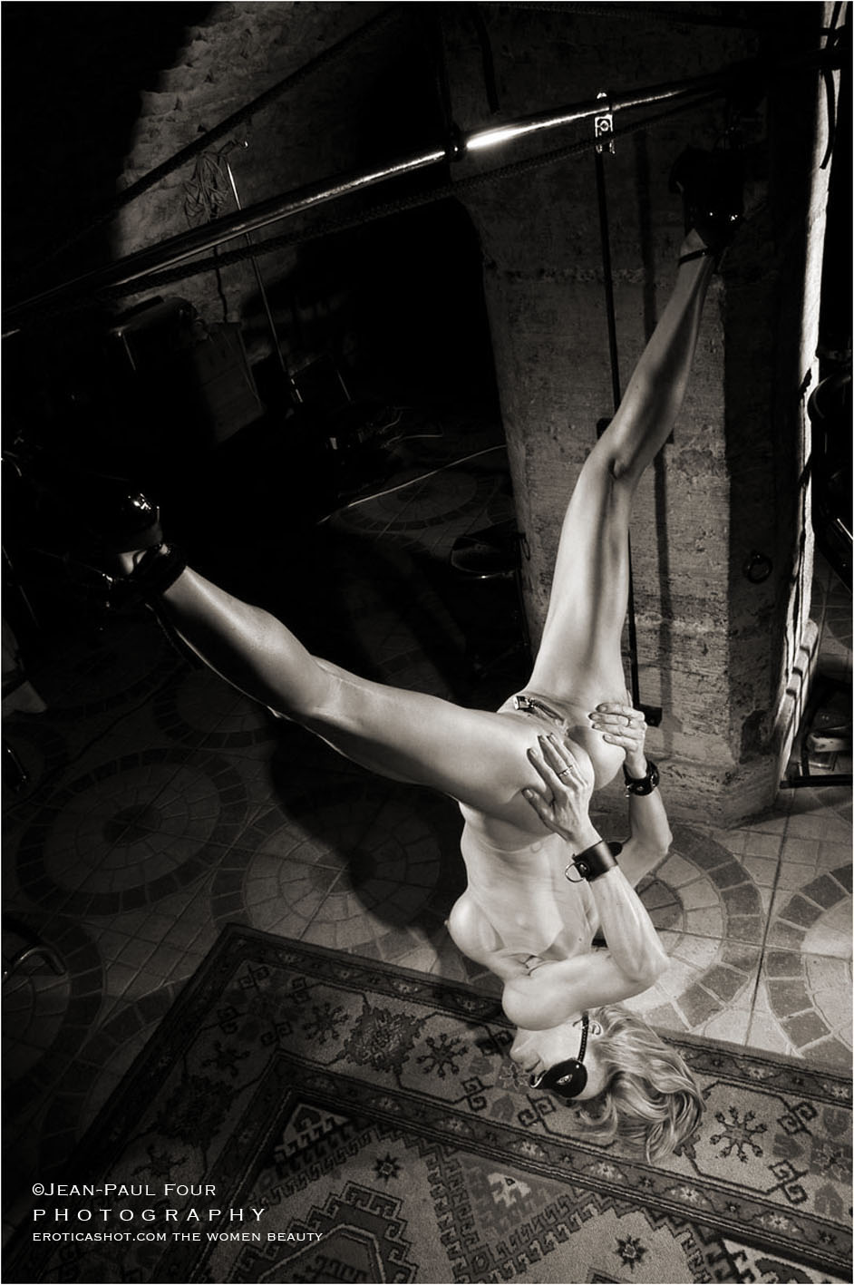nice pict of Marie, suspended by the feet legs wide open, in the PLS cellar in Paris, sub and friend, pee girl, pisseuse, black corset and red ballet shoes, and piercings on labias, follow her on eroticashot.com, pict by ©Jean-Paul Four